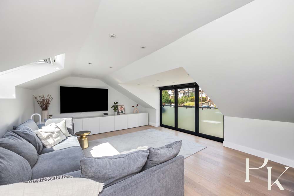 Cosy loft living room with skylight renovation in Hove